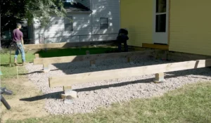 Deck foundation being installed with secure posts and beams—start building your dream deck today.