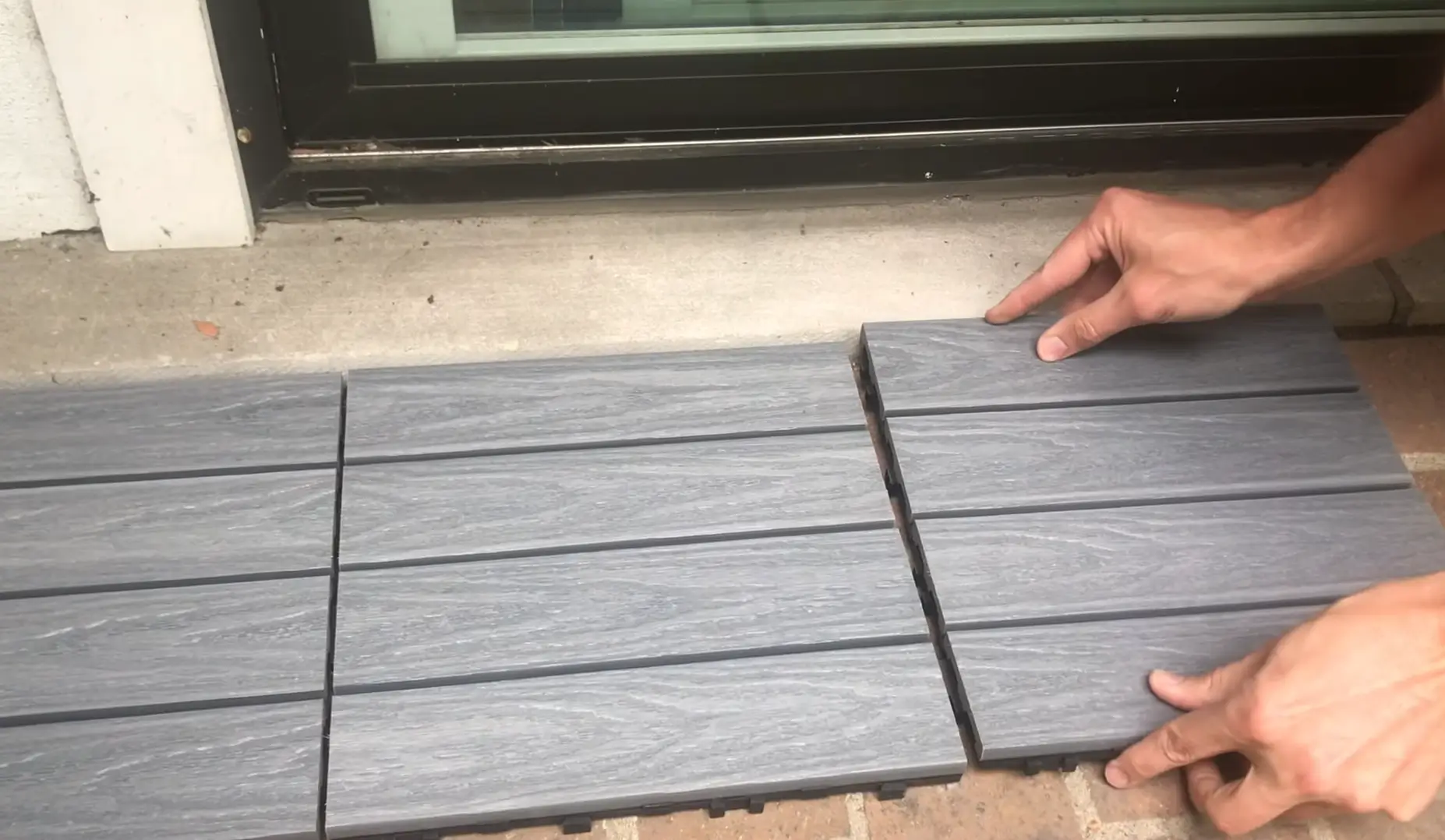 Installing interlocking deck tiles. Upgrade your outdoor space easily—hire a professional contractor to install your deck tiles for a flawless finish.